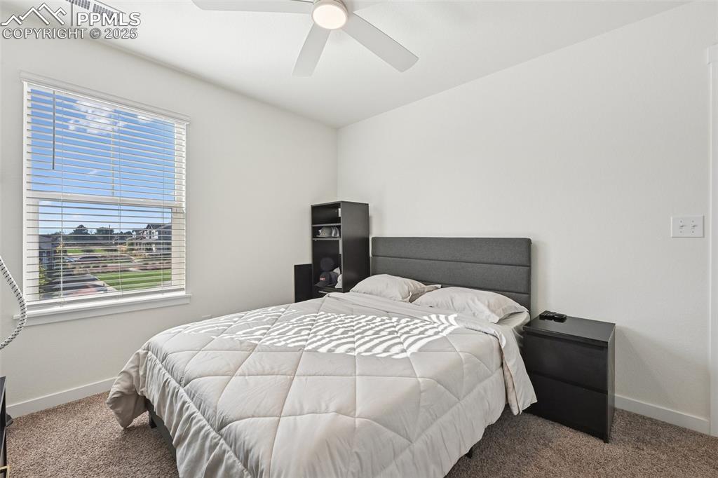 Image 34 of 35: Bedroom with carpet and a ceiling fan