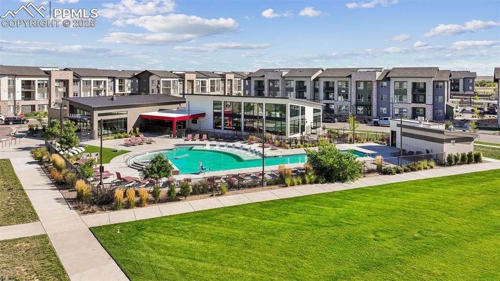 Image 9 of 35: Community pool with a residential view