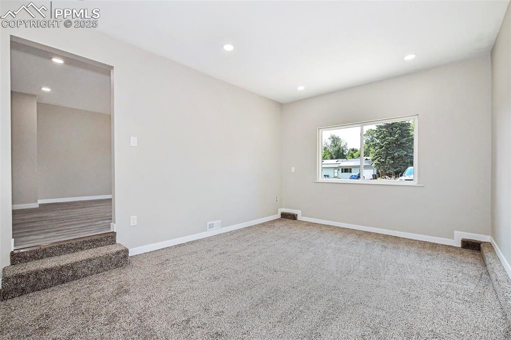 Image 11 of 25: Unfurnished room featuring recessed lighting and light carpet