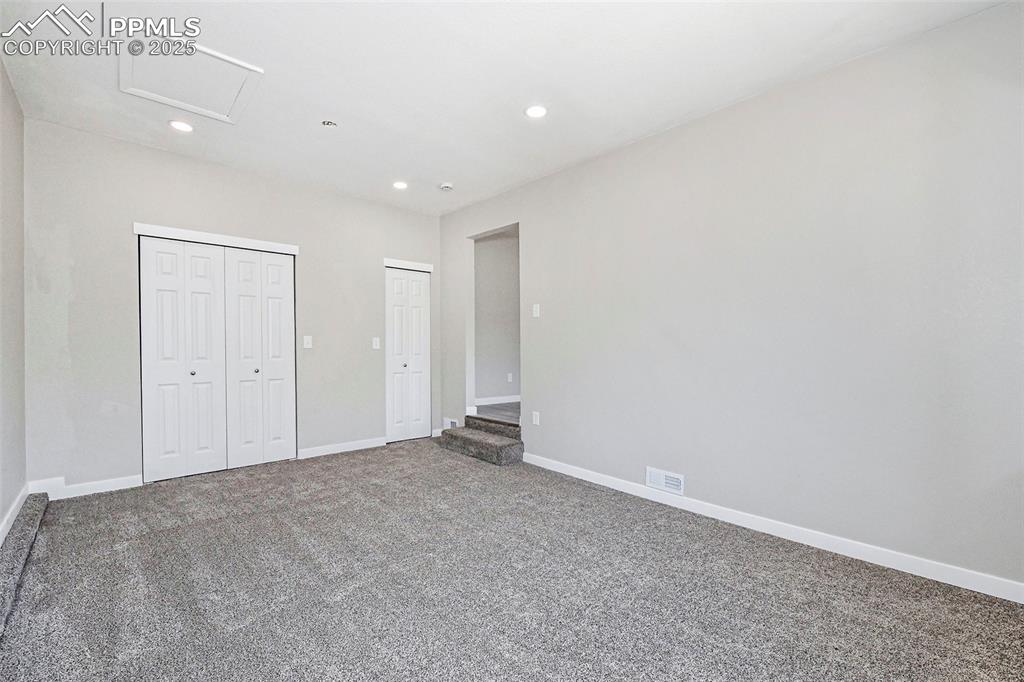 Image 12 of 25: Unfurnished bedroom featuring carpet flooring, recessed lighting, attic acc