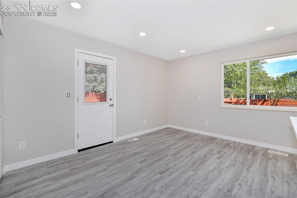 Image 14 of 25: Unfurnished room with recessed lighting, light wood-type flooring, and heal