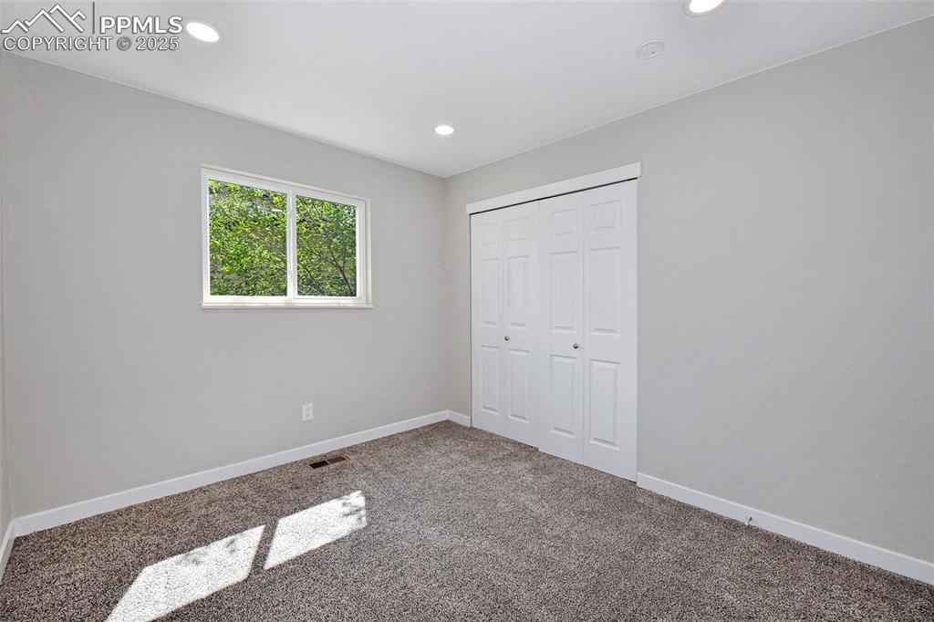 Image 17 of 25: Unfurnished bedroom featuring carpet floors, recessed lighting, and a close