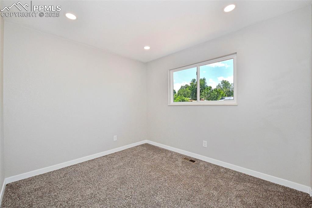 Image 18 of 25: Empty room featuring carpet flooring and recessed lighting