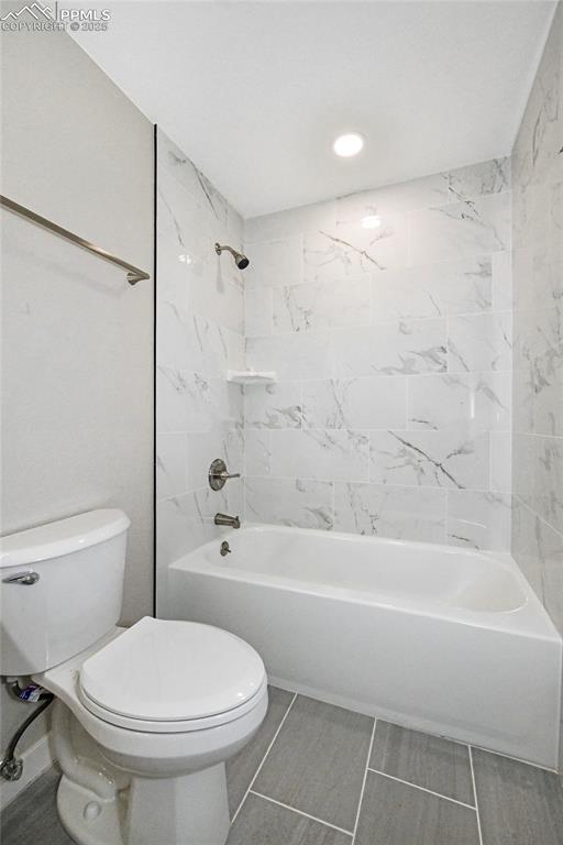 Image 7 of 25: Bathroom with tub / shower combination and toilet