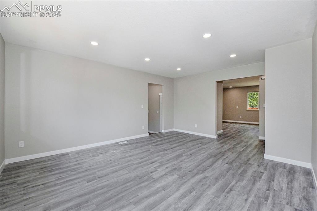 Image 8 of 25: Empty room featuring light wood-style floors and recessed lighting