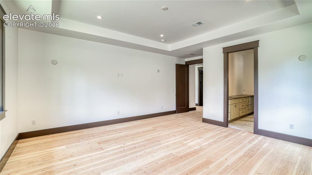 Image 14 of 37: MAIN LEVEL MASTER BEDROOM SUITE