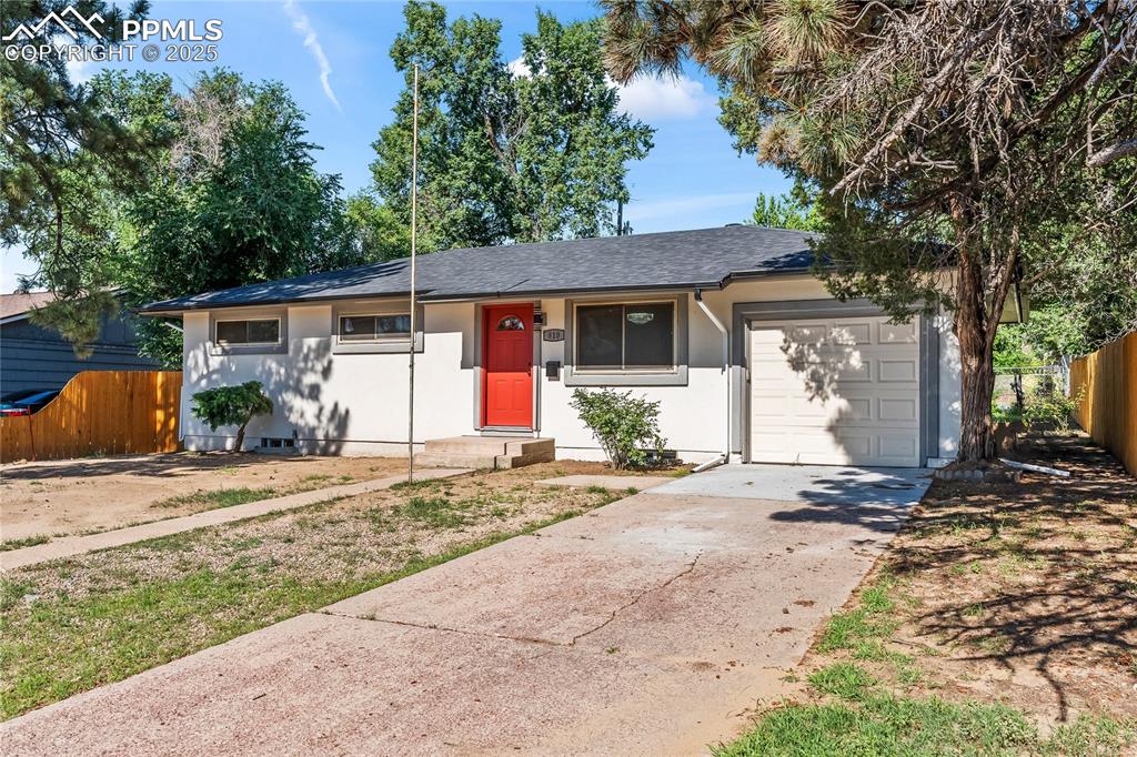 Image 2 of 36: Ranch-style house with a garage, driveway, stucco siding, and a shingled ro