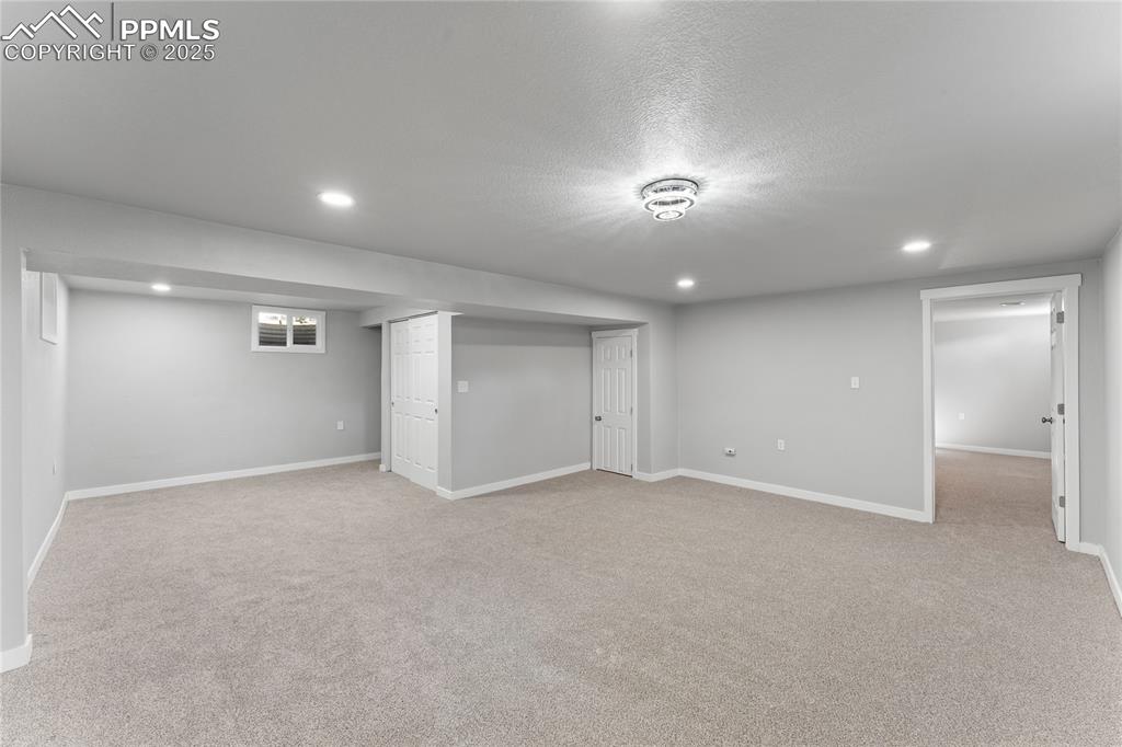 Image 22 of 36: Finished below grade area featuring recessed lighting, carpet floors, and a