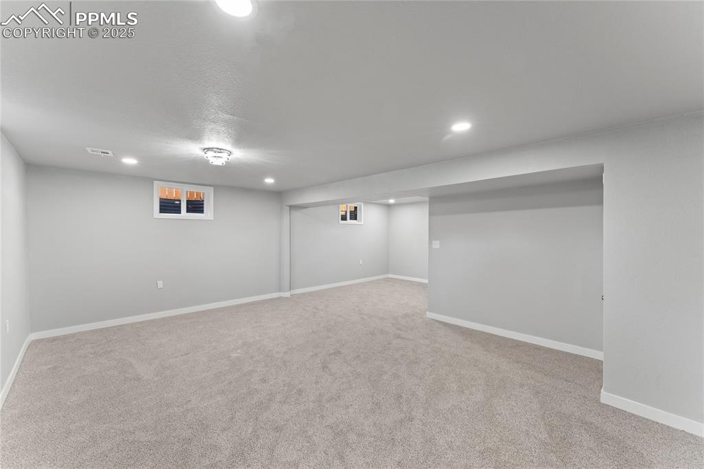 Image 23 of 36: Finished basement with carpet floors and recessed lighting