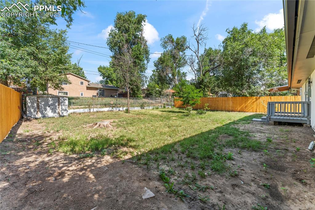 Image 32 of 36: View of fenced backyard
