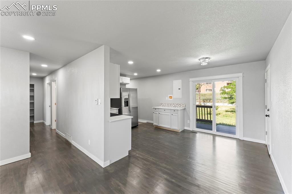 Image 5 of 36: Kitchen with stainless steel refrigerator with ice dispenser, light counter