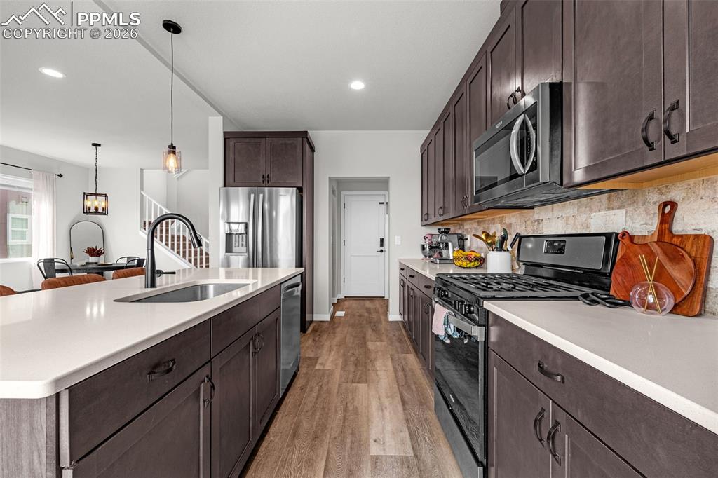 Image 10 of 40: Kitchen featuring stainless steel appliances, dark espresso finished cabine