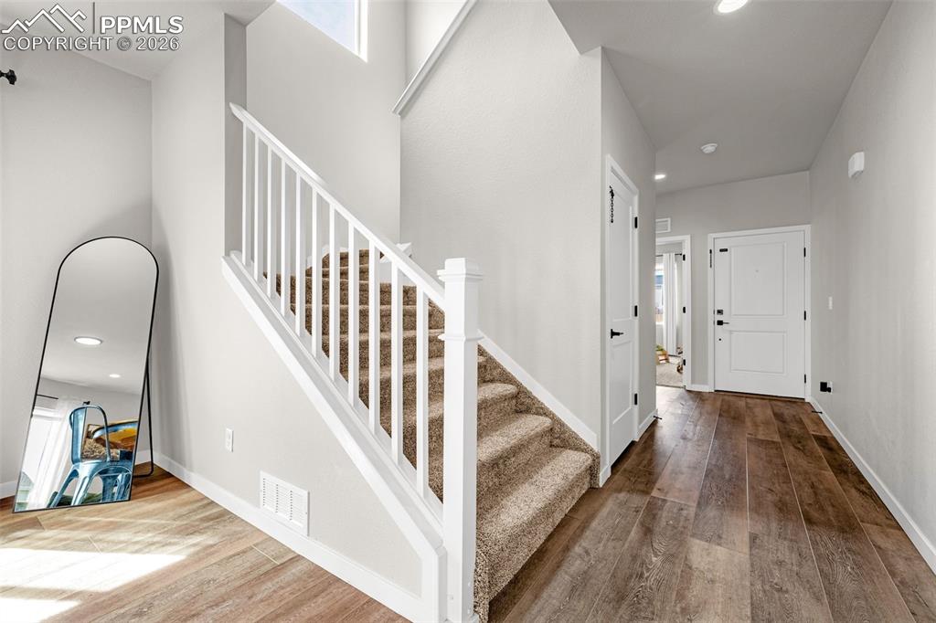 Image 13 of 40: Open stairs featuring recessed lighting and wood-type flooring