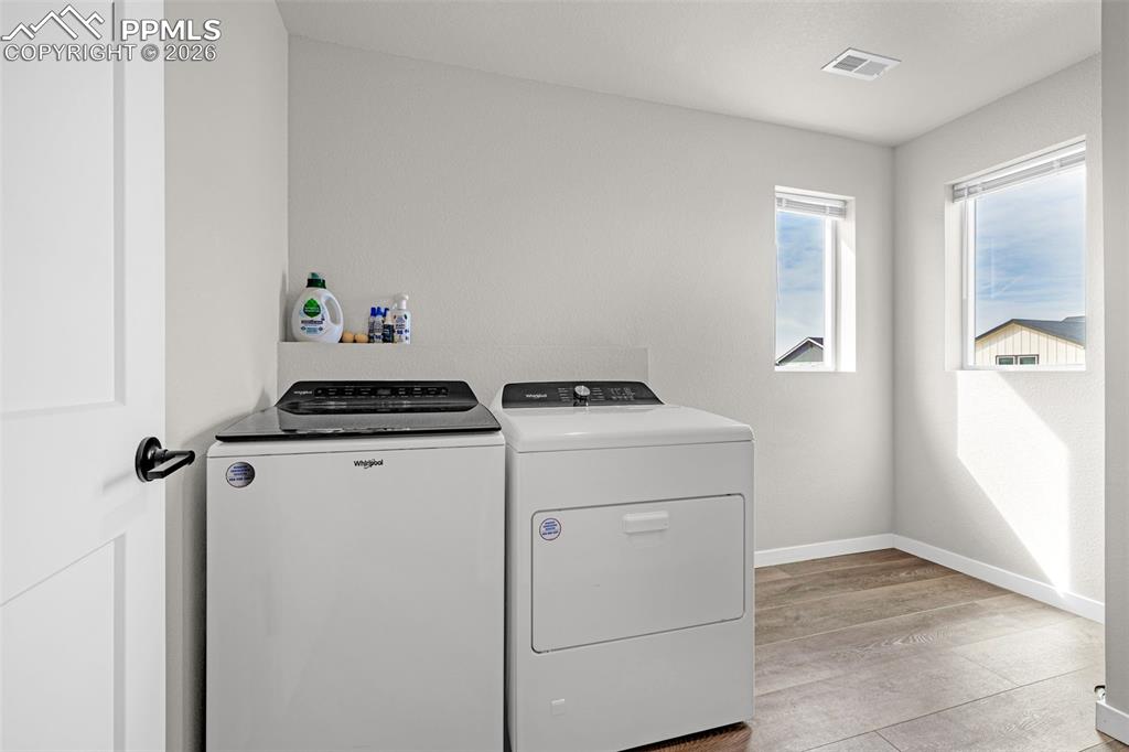 Image 19 of 40: Huge laundry room with windows; great natural light, plenty of room for sto