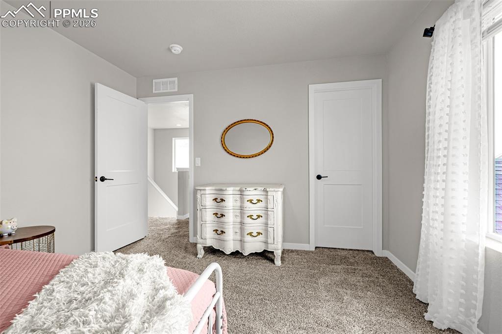 Image 26 of 40: Second spacious bedroom on the upper level with fresh clean carpet, great n