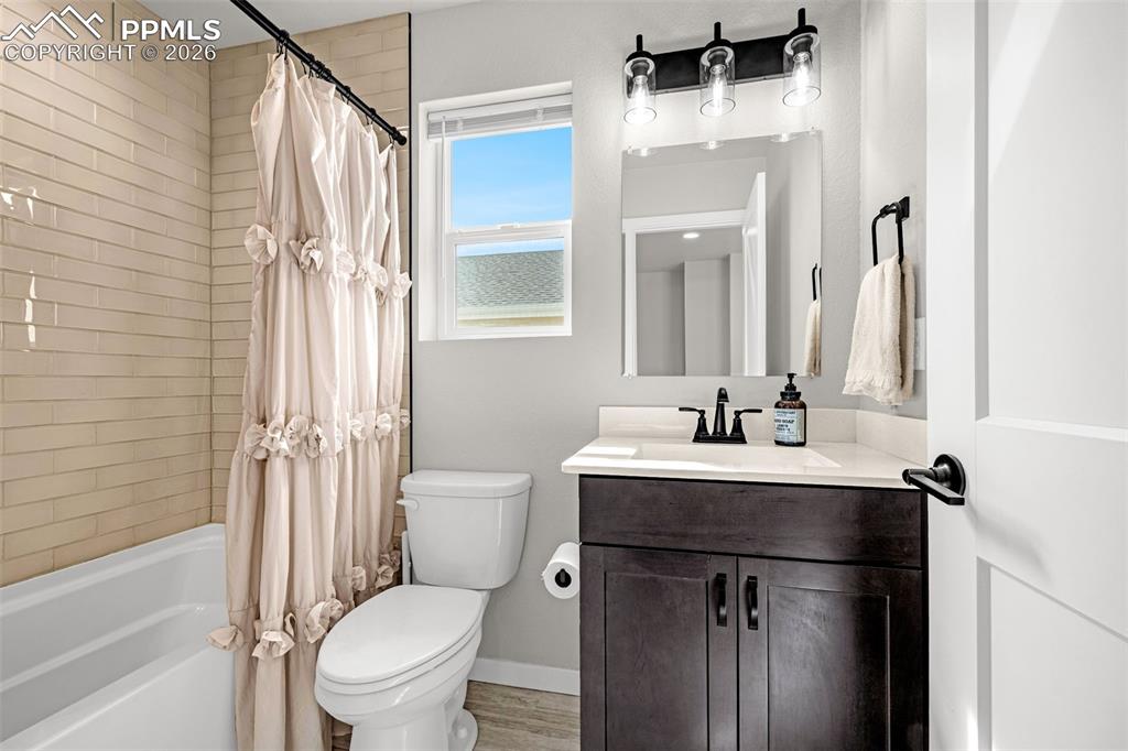 Image 27 of 40: Second full bathroom on the upper level featuring a granite vanity and show