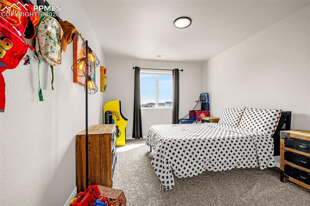 Image 28 of 40: Third spacious bedroom on the upper level with fresh clean carpet, great na