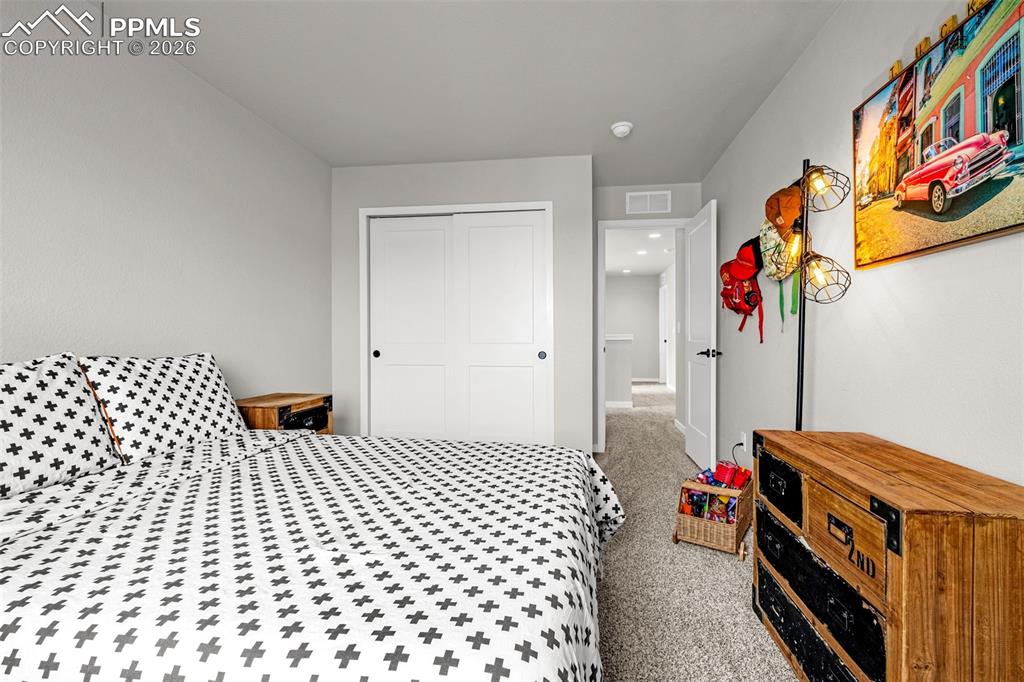 Image 29 of 40: Third spacious bedroom on the upper level with fresh clean carpet, great na