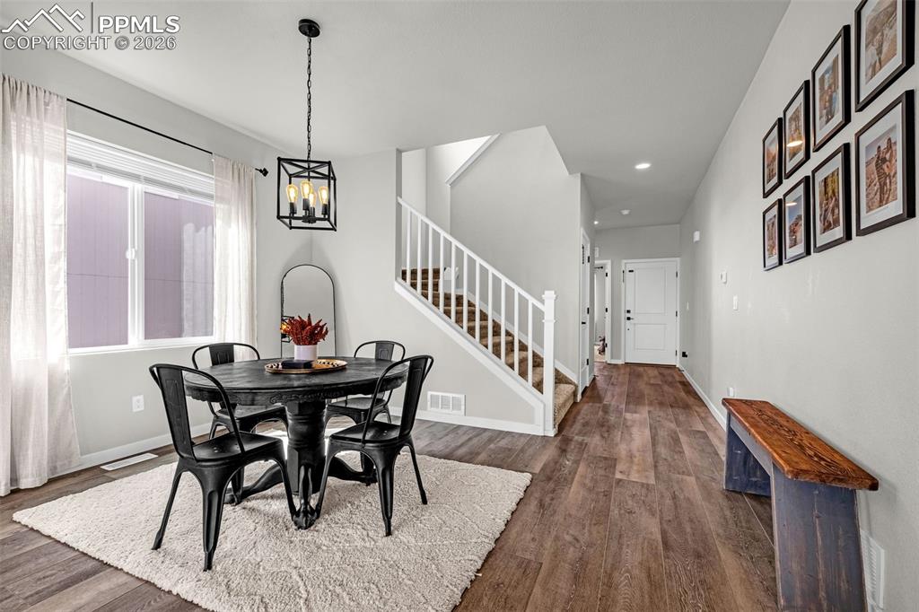 Image 3 of 40: Dining area on main level, great natural light, luxury vinyl plank flooring