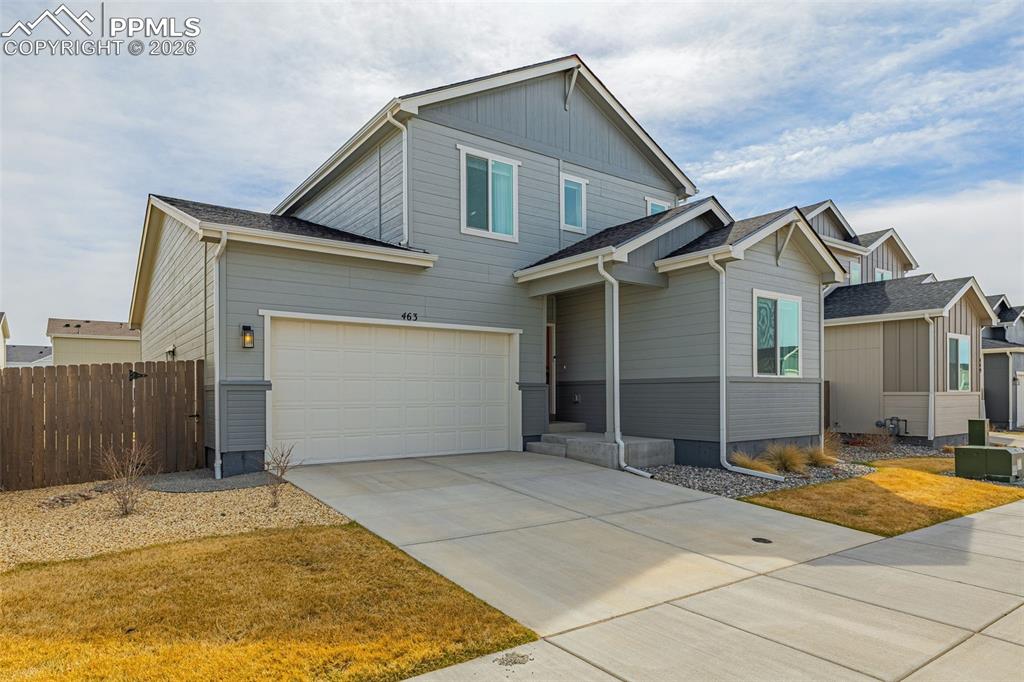 Image 36 of 40: View of front of house with concrete driveway, with 3-car attached tandem g