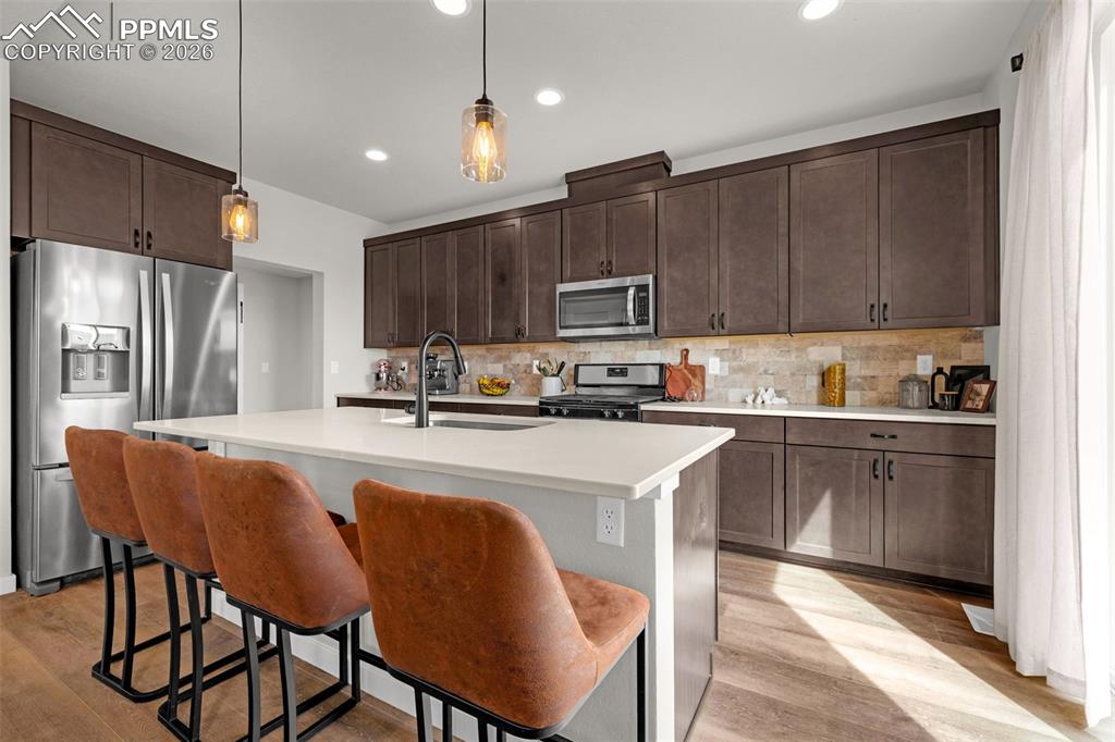 Image 6 of 40: Kitchen featuring stainless steel appliances, dark espresso finished cabine