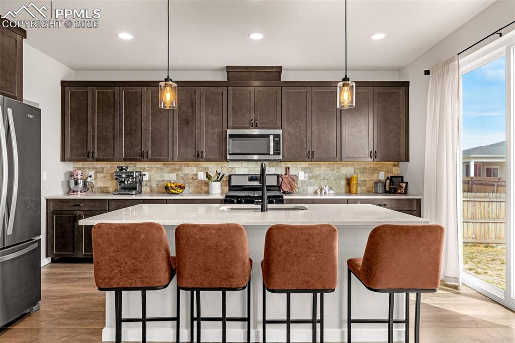 Image 7 of 40: Kitchen featuring stainless steel appliances, dark espresso finished cabine