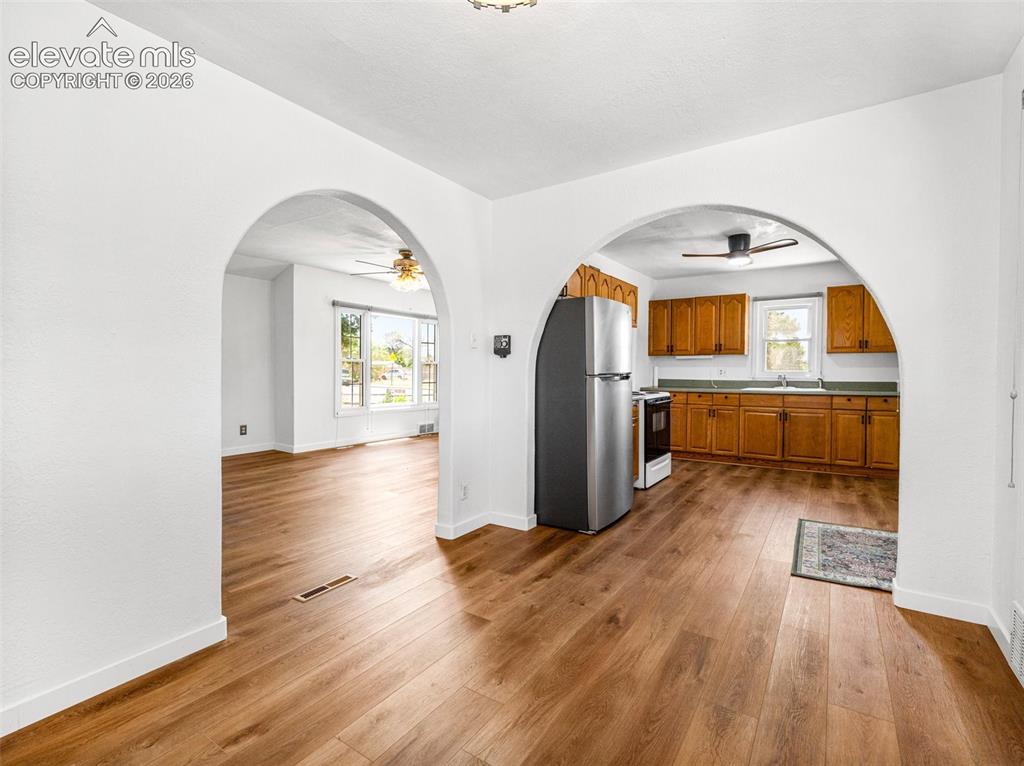 Image 19 of 37: From dining room looking into kitchen and living room
