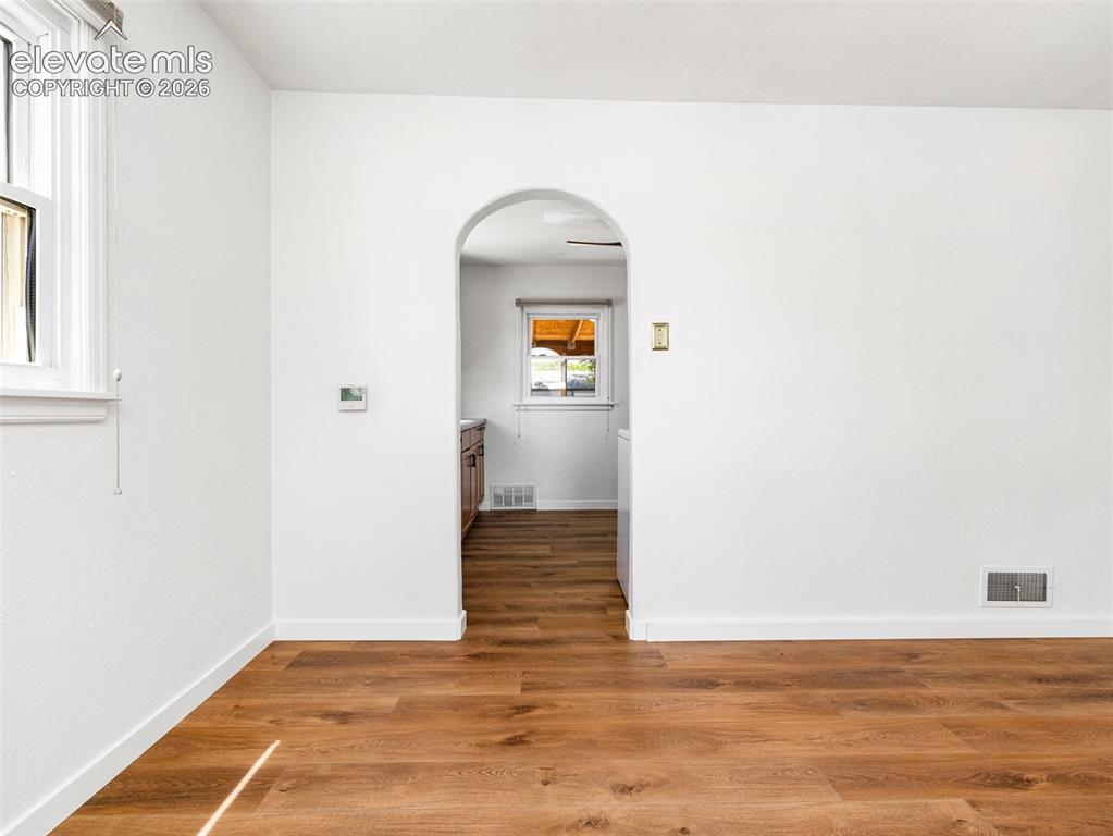 Image 21 of 37: Archway to kitchen