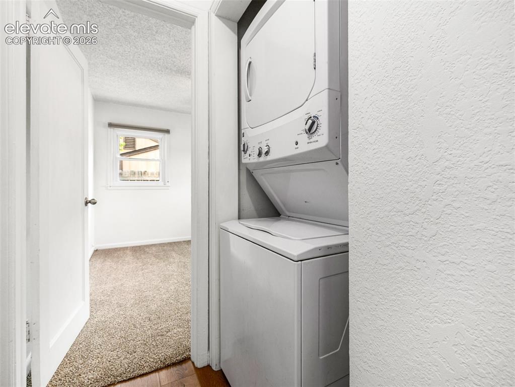 Image 24 of 37: Laundry space is in a closet in hallway