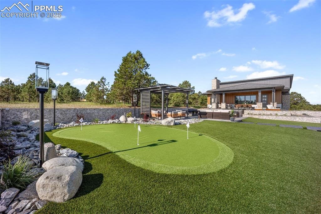 Image 50 of 50: Putting green with casita in the back.