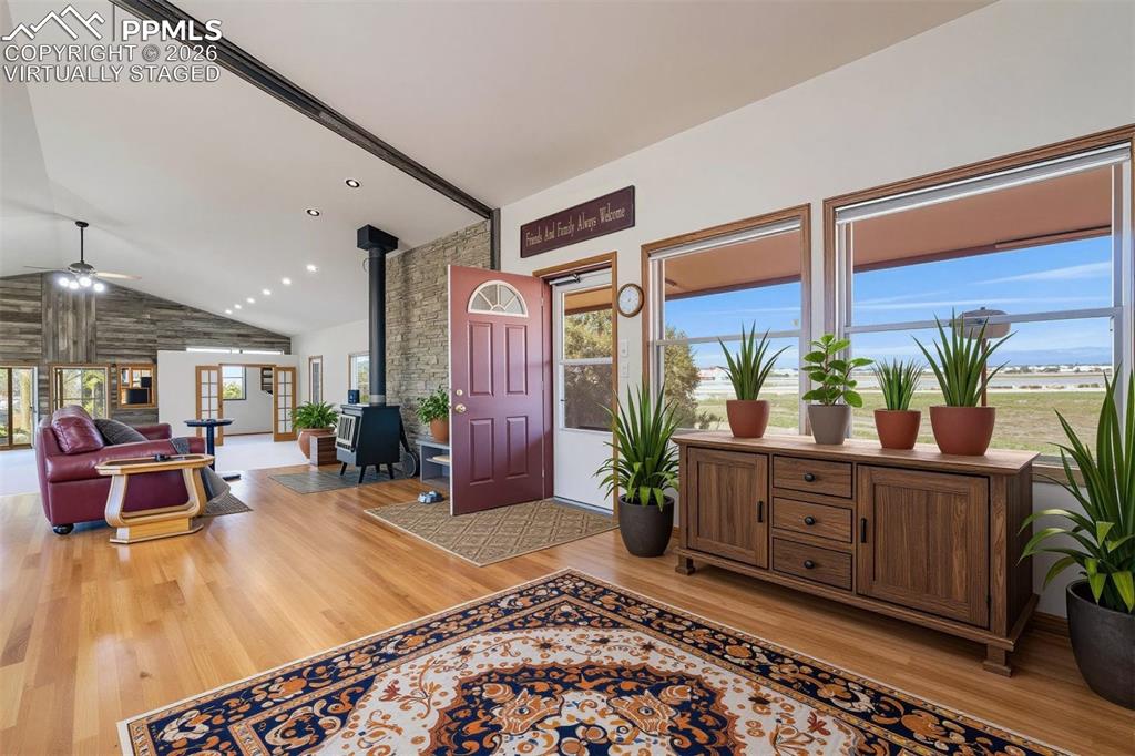 Image 3 of 50: virtually staged Open concept interior featuring hardwood flooring, a vault