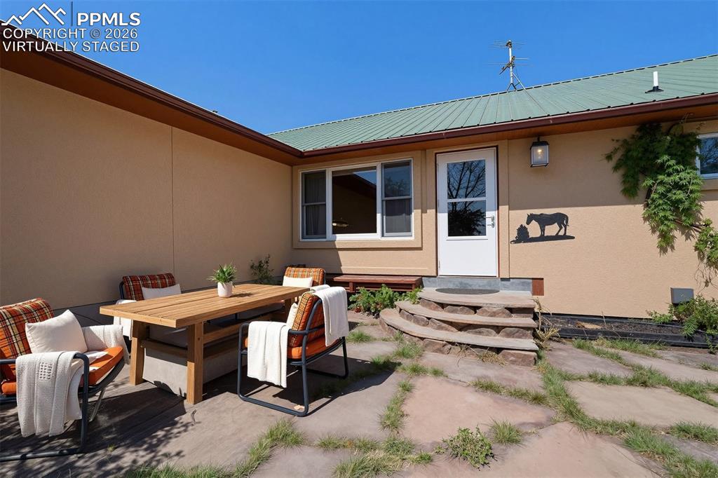 Image 41 of 50: virtually staged Outdoor patio area featuring large flagstone pavers, a lig