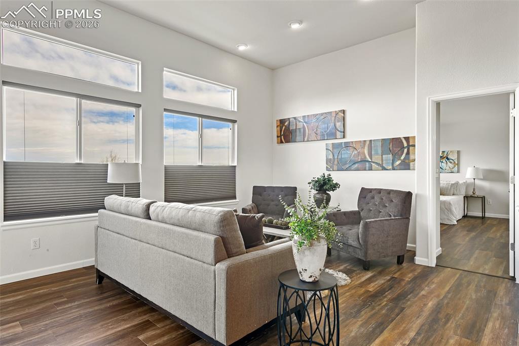 Image 13 of 48: Large windows with according shades and transom windows