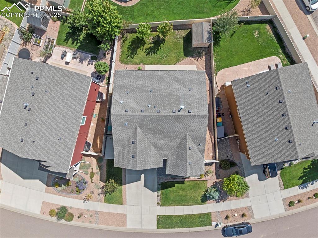 Image 25 of 32: Fully fenced backyard with large storage shed