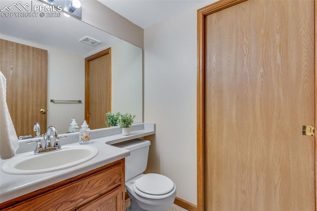 Image 19 of 34: 1/2 bath on main floor, pocket door leads to laundry room