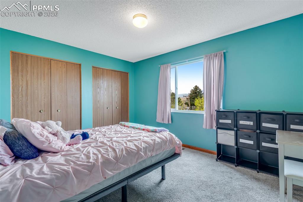 Image 26 of 34: Corner bedroom upstairs