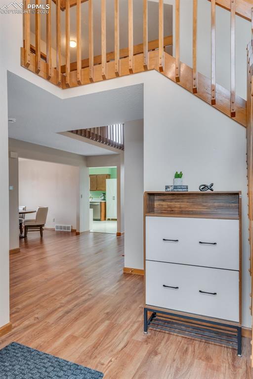 Image 7 of 34: Entry from the front door. Stairs to the right to go upstairs, stairs to t