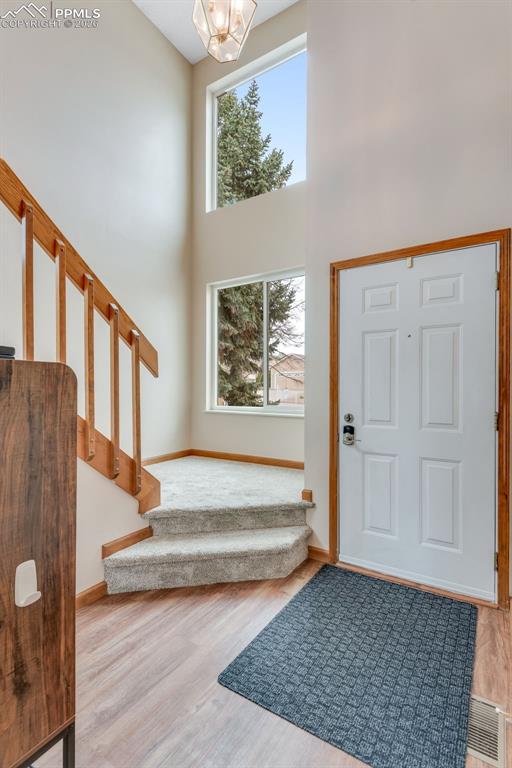 Image 8 of 34: Front door view with big picture windows