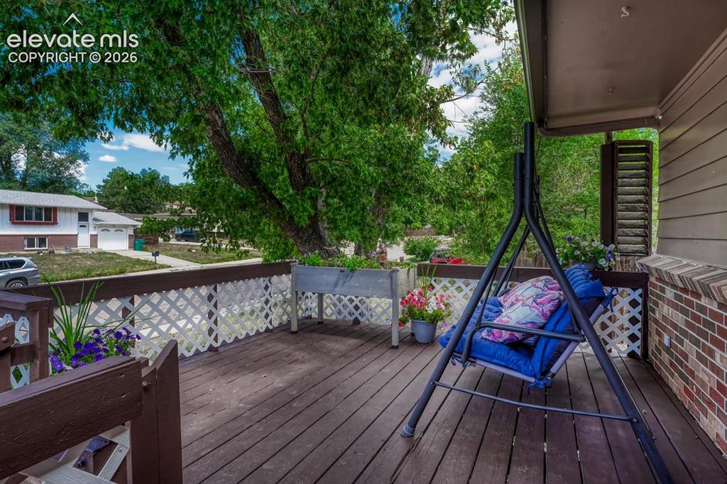 Image 2 of 50: Expansive outdoor deck featuring wood-finish flooring, white lattice railin