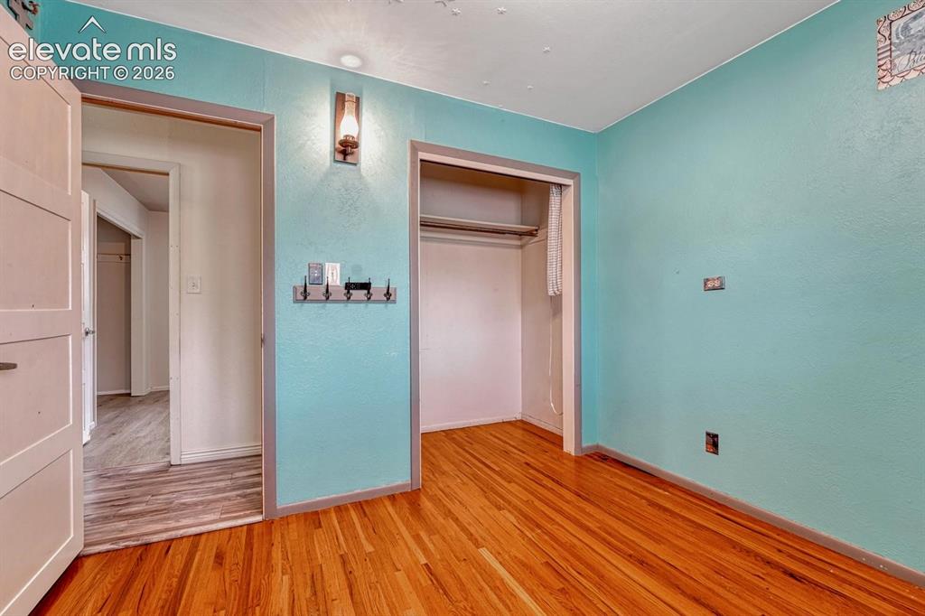 Image 29 of 50: Light-filled interior space featuring wood-finish flooring and a closet