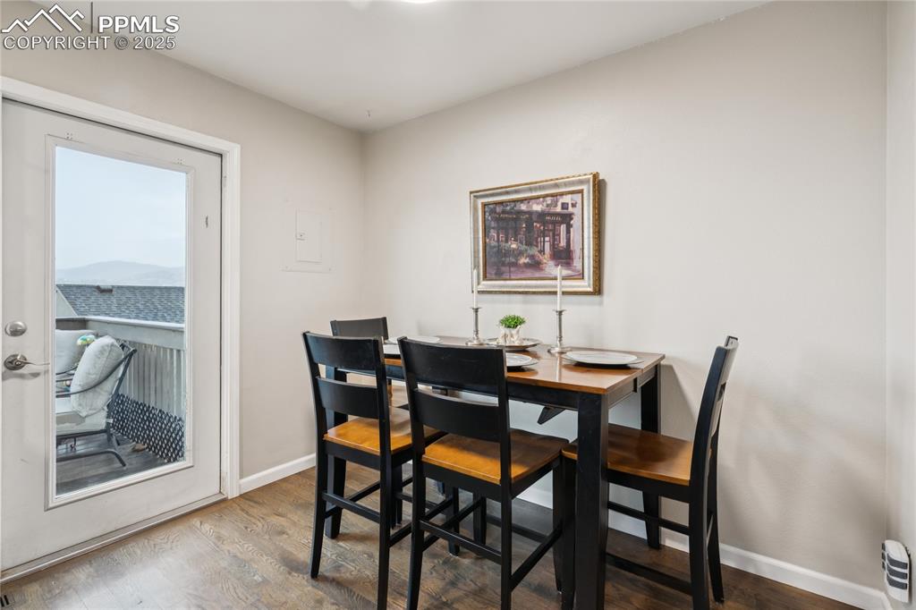Image 10 of 21: Dining room featuring wood finished floors and baseboards