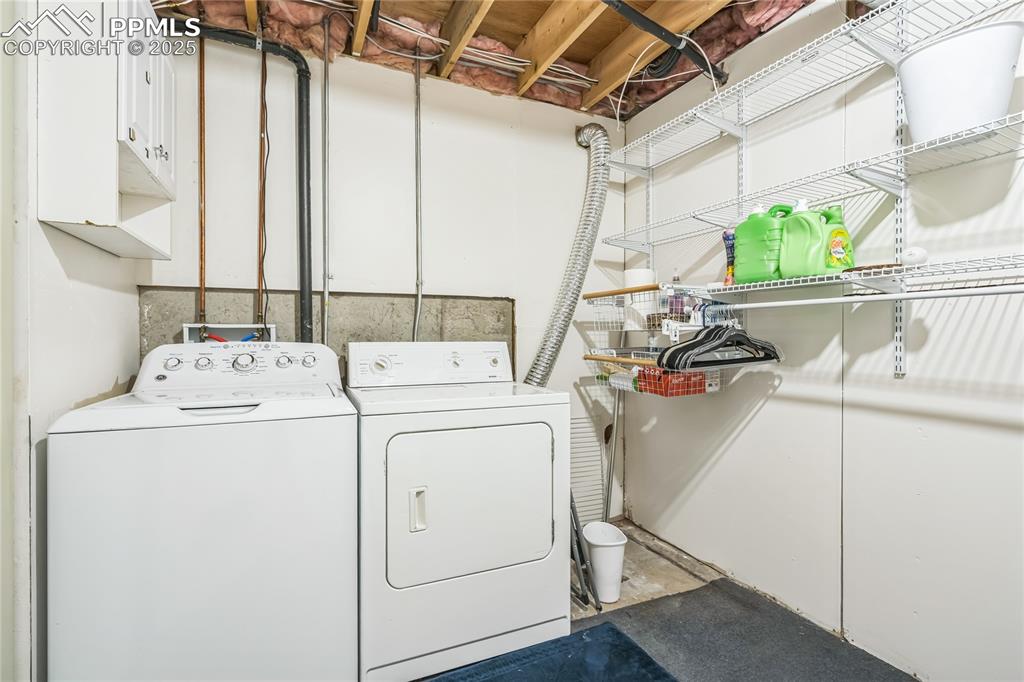 Image 14 of 21: Laundry area featuring washing machine and dryer
