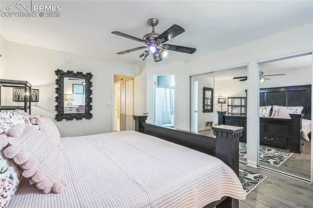 Image 8 of 21: Bedroom with wood finished floors and ceiling fan