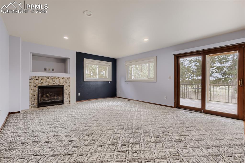 Image 12 of 48: Family room with breakfast nook and deck access.