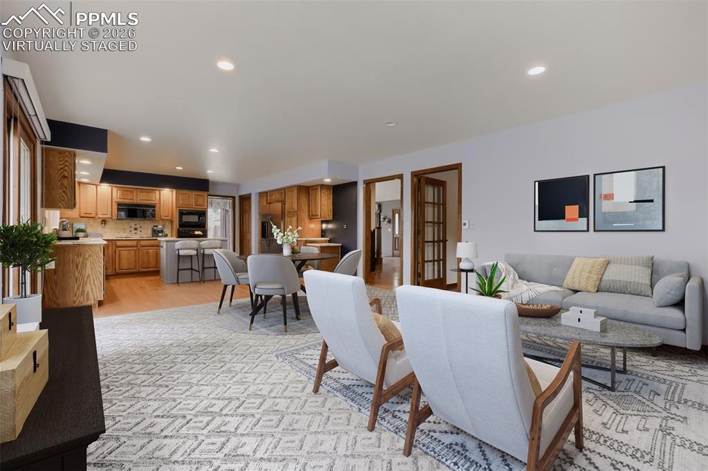 Image 13 of 48: Virtually staged family room with breakfast nook and deck access.