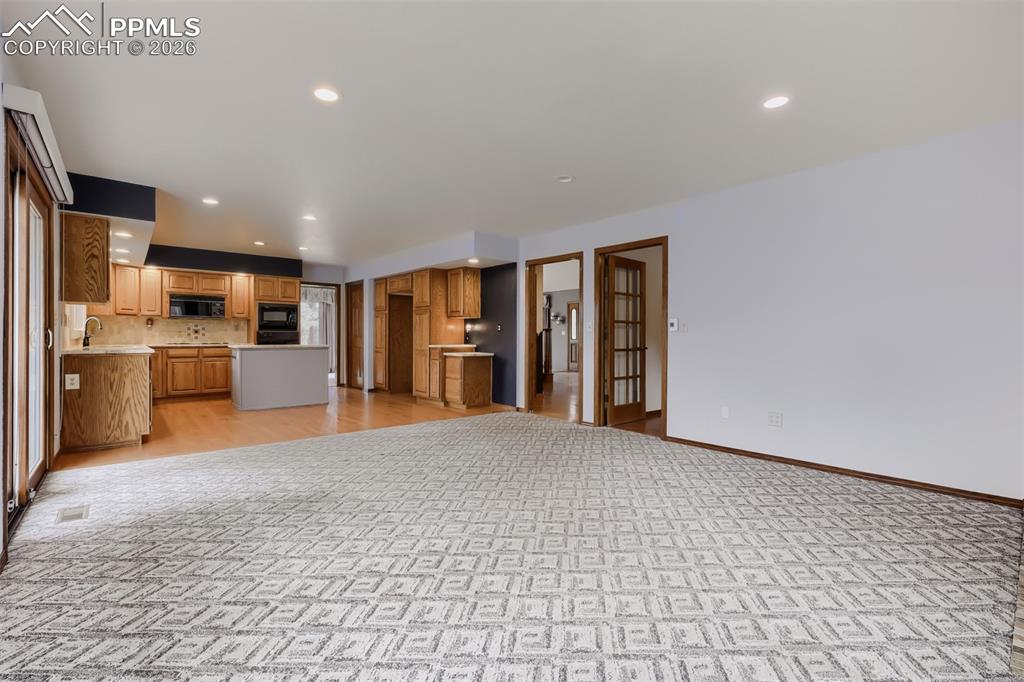 Image 14 of 48: Family room with breakfast nook and deck access.