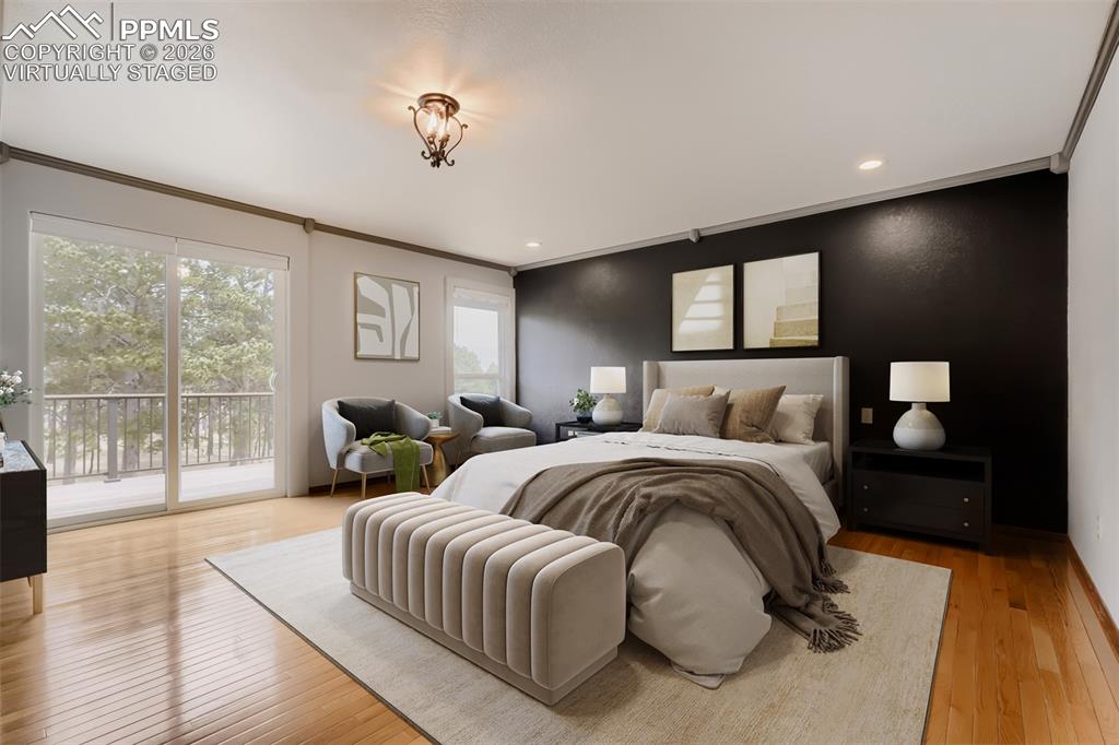 Image 21 of 48: Virtually staged primary bedroom with walk out, seating area, large walk-in