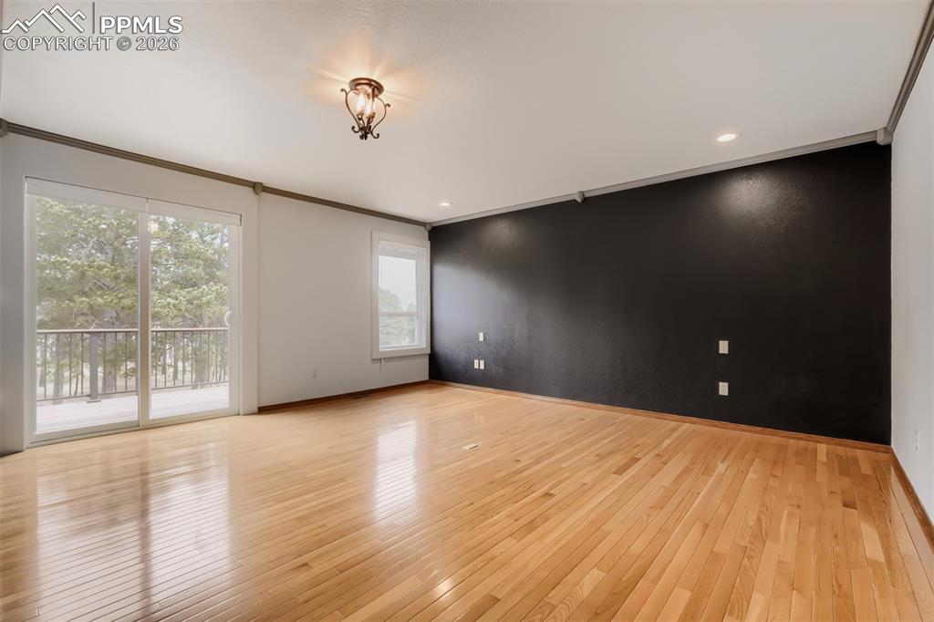 Image 22 of 48: Primary bedroom with walk out, seating area, large walk-in closet, and remo