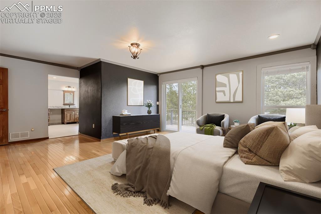 Image 23 of 48: Virtually staged primary bedroom with walk out, seating area, large walk-in