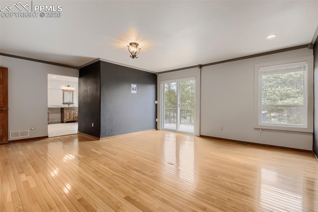 Image 24 of 48: Primary bedroom with walk out, seating area, large walk-in closet, and remo